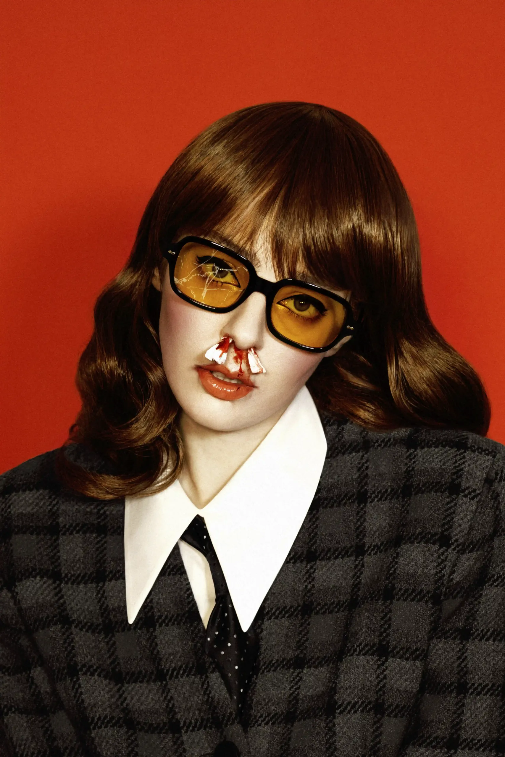 Artistic portrait by Valeria Vavoom. The protagonist in this picture is a girl, probably victim of an aggression. She has blood running from her nose and she poses with big yellow sunglasses. One of the lens is broken.